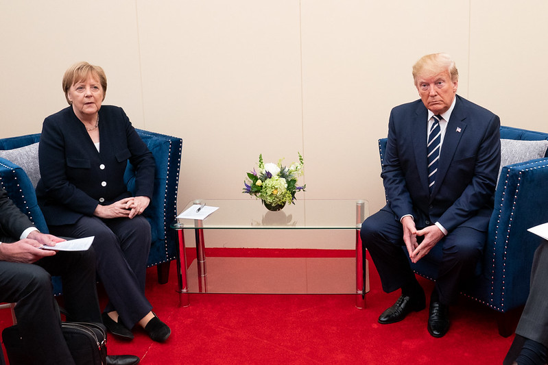 Donald Trump, furious how small his hands are compared to Angela Merkel's hands.